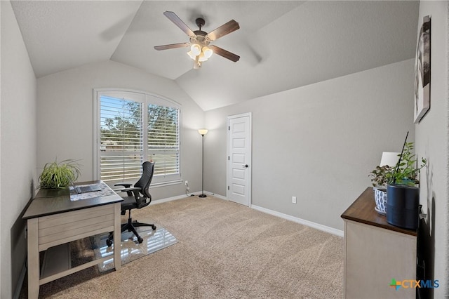 home office with baseboards, a ceiling fan, carpet, and vaulted ceiling