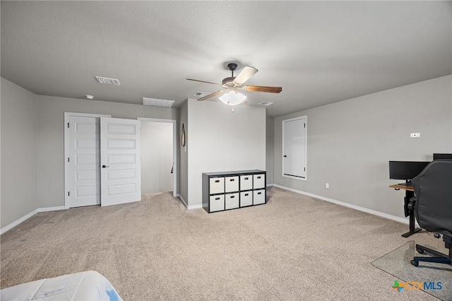 interior space featuring visible vents, baseboards, and ceiling fan