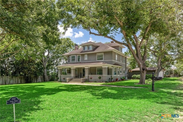 1004 Mitchell St, Gonzales, TX 78629 - american foursquare style home with stucco siding and covered porch