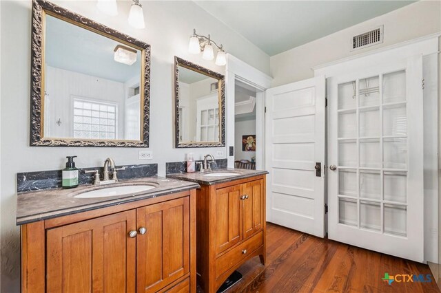 1004 Mitchell St, Gonzales, TX 78629 - bathroom featuring vanity and wood finished floors