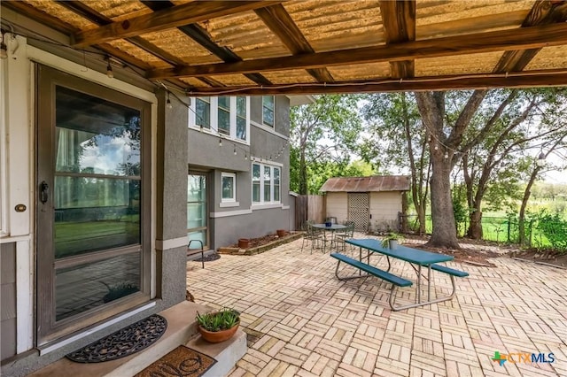 1004 Mitchell St, Gonzales, TX 78629 - view of patio featuring outdoor dining area and an outbuilding