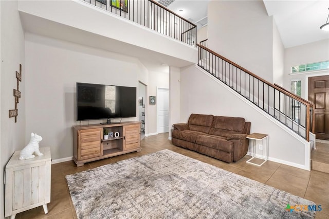 11602 Buster Crabbe Dr, Austin, TX 78748 - living room featuring a high ceiling, tile patterned floors, and stairs