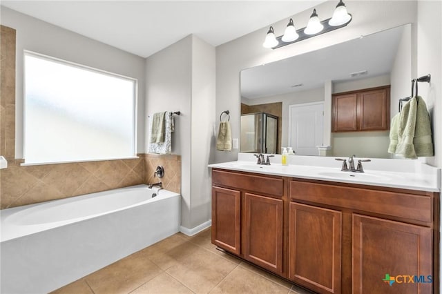 11602 Buster Crabbe Dr, Austin, TX 78748 - bathroom featuring a garden tub, tile patterned flooring, double vanity, and a stall shower