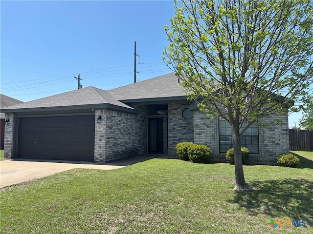 4207 Hitchrock Dr, Killeen, TX 76549 - ranch-style home with a front yard, an attached garage, brick siding, driveway, and roof with shingles