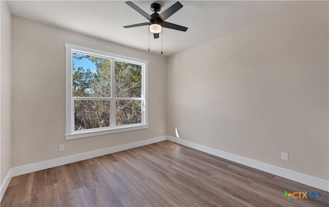 1435 Redwood Rd, Fischer, TX 78623 - unfurnished room featuring wood finished floors, baseboards, and ceiling fan