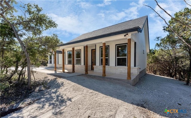1435 Redwood Rd, Fischer, TX 78623 - back of property with covered porch, roof with shingles, and stone siding
