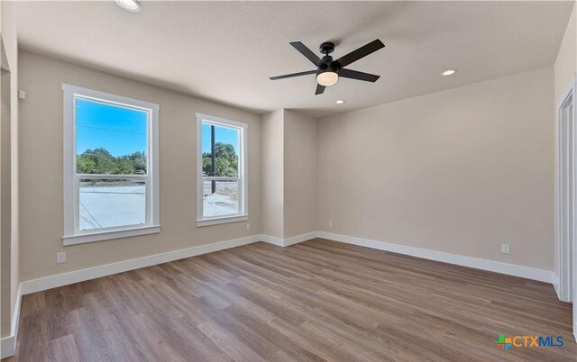 1435 Redwood Rd, Fischer, TX 78623 - unfurnished room featuring wood finished floors, baseboards, ceiling fan, and recessed lighting