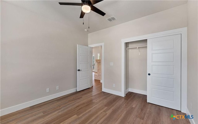 1435 Redwood Rd, Fischer, TX 78623 - unfurnished bedroom with baseboards, wood finished floors, a closet, and ceiling fan