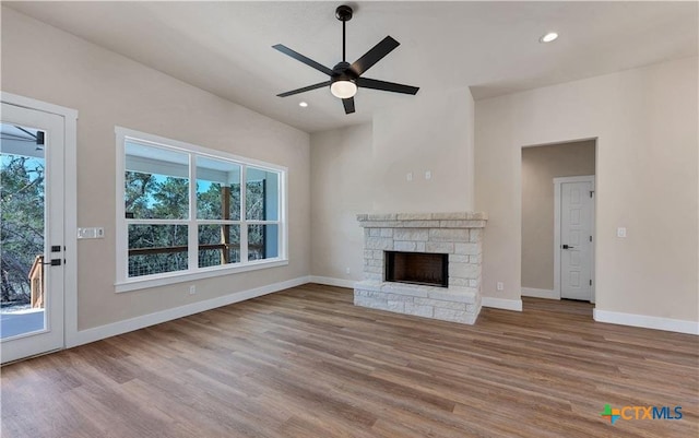 1435 Redwood Rd, Fischer, TX 78623 - unfurnished living room with a ceiling fan, wood finished floors, a fireplace, baseboards, and recessed lighting