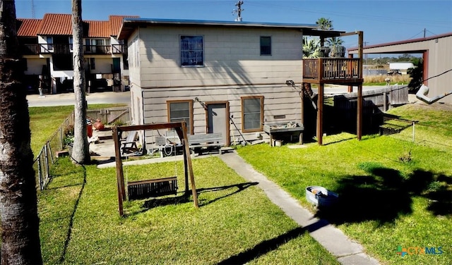 415 S 15th St, Port Oconnor, TX 77982 - back of house featuring fence, a deck, and a yard