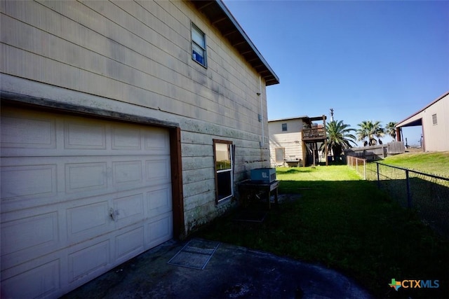 415 S 15th St, Port Oconnor, TX 77982 - view of side of property featuring a lawn, a garage, and fence