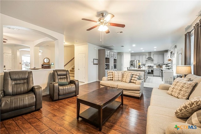 living room featuring dark hardwood / wood-style floors and ceiling fan