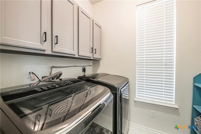 laundry area featuring cabinets and washer and clothes dryer