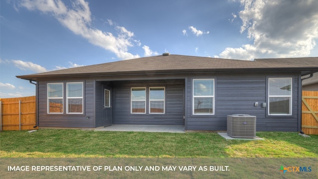 back of property with a patio, a yard, and central AC