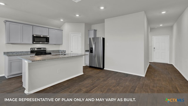 kitchen with light stone countertops, gray cabinetry, stainless steel appliances, dark hardwood / wood-style floors, and an island with sink