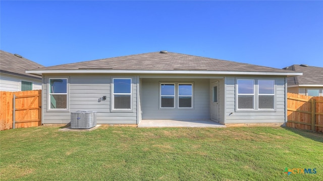 back of house featuring a patio, central AC, and a lawn