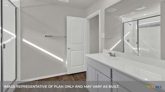 bathroom with vanity, hardwood / wood-style flooring, and walk in shower