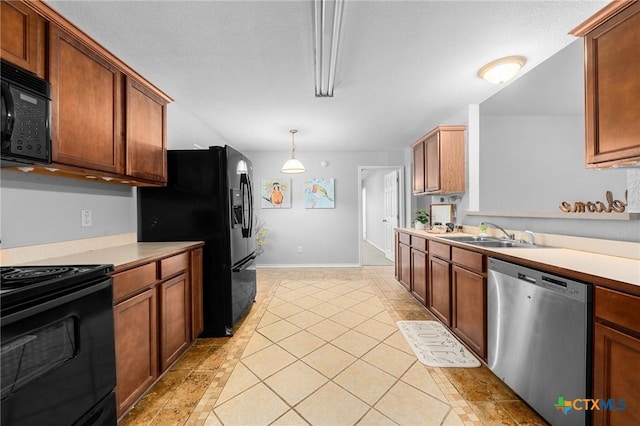 kitchen featuring pendant lighting, sink, light tile patterned floors, and black appliances