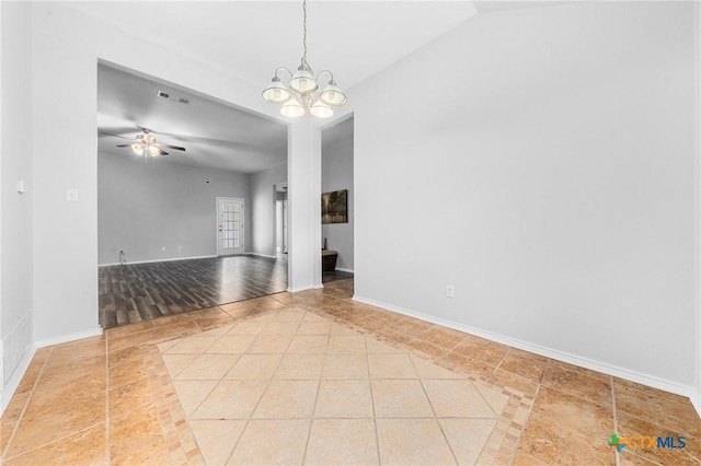 unfurnished room with ceiling fan with notable chandelier and light tile patterned floors