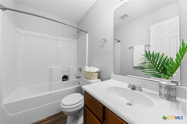 full bathroom with bathtub / shower combination, vanity, hardwood / wood-style flooring, and toilet