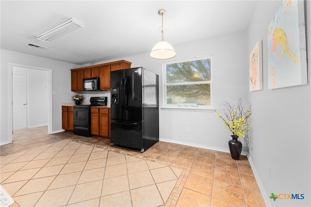 kitchen with light tile patterned flooring, hanging light fixtures, and black appliances