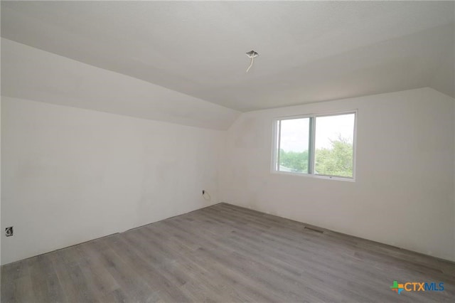 120 Retama Ln, Rockport, TX 78382 - additional living space featuring lofted ceiling, visible vents, and wood finished floors