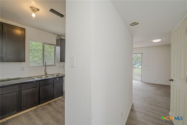 120 Retama Ln, Rockport, TX 78382 - corridor with baseboards, wood finished floors, and a sink
