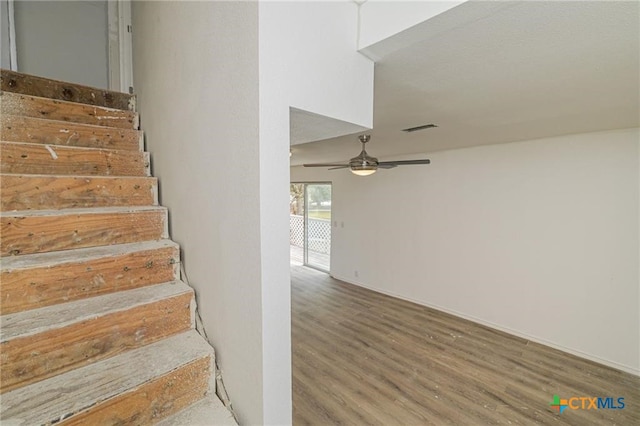 120 Retama Ln, Rockport, TX 78382 - stairs with baseboards, a ceiling fan, wood finished floors, and visible vents