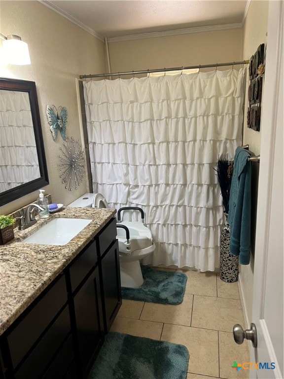 bathroom featuring toilet, vanity, tile patterned flooring, and ornamental molding