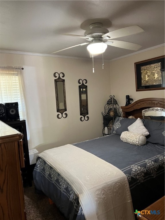 carpeted bedroom with ornamental molding and ceiling fan