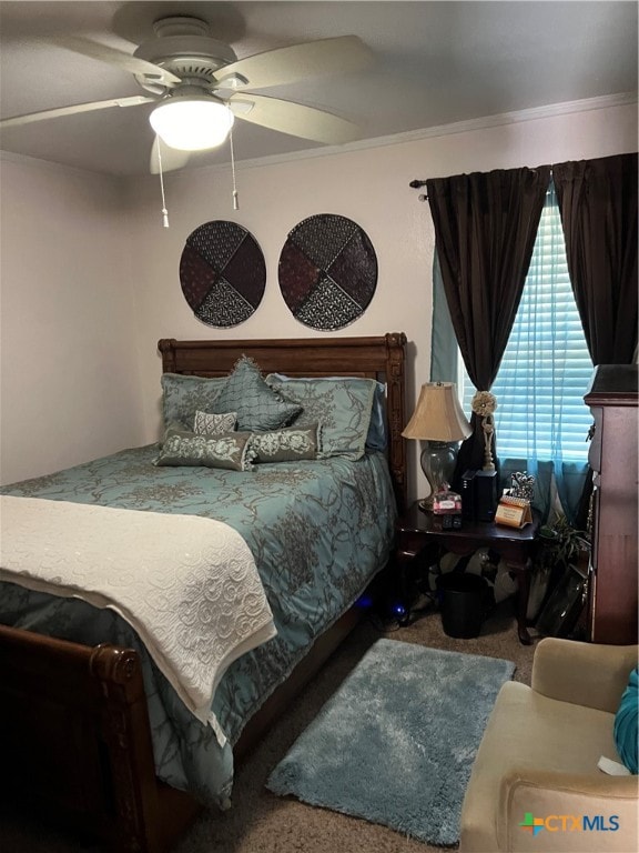 carpeted bedroom featuring ceiling fan and crown molding