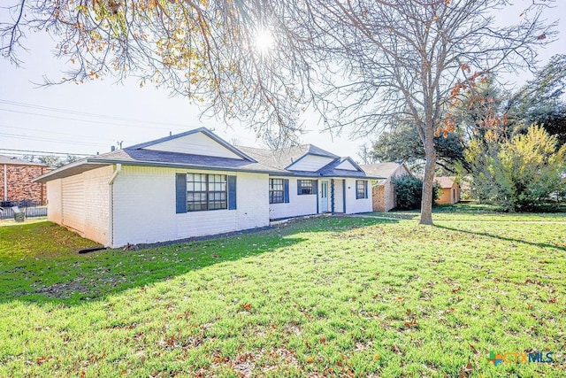 ranch-style house with a front lawn