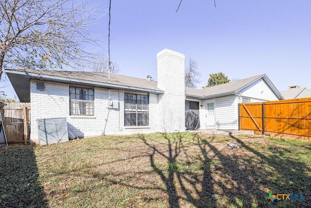 rear view of house with a lawn