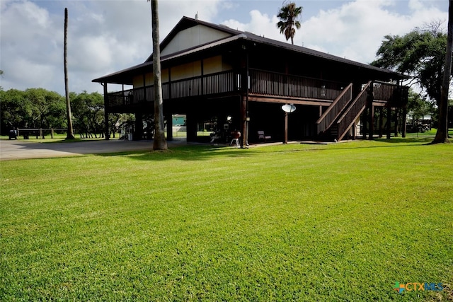 exterior space with a deck and a lawn