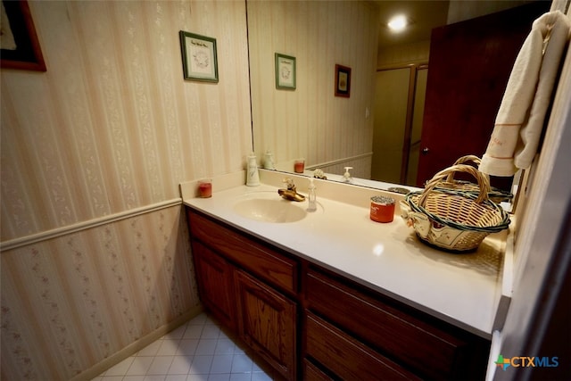 bathroom with vanity, a shower with door, and tile patterned flooring