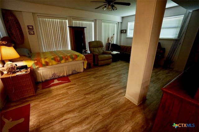 bedroom with wood-type flooring and ceiling fan