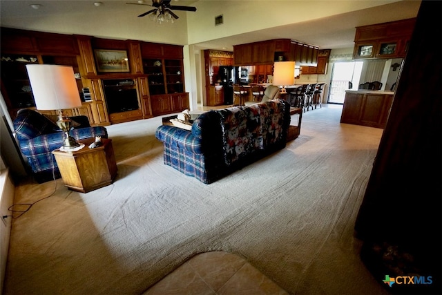 living room featuring light colored carpet and ceiling fan