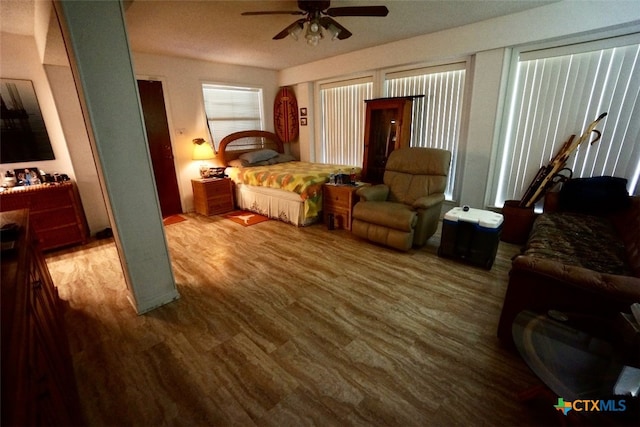 bedroom with hardwood / wood-style floors and ceiling fan