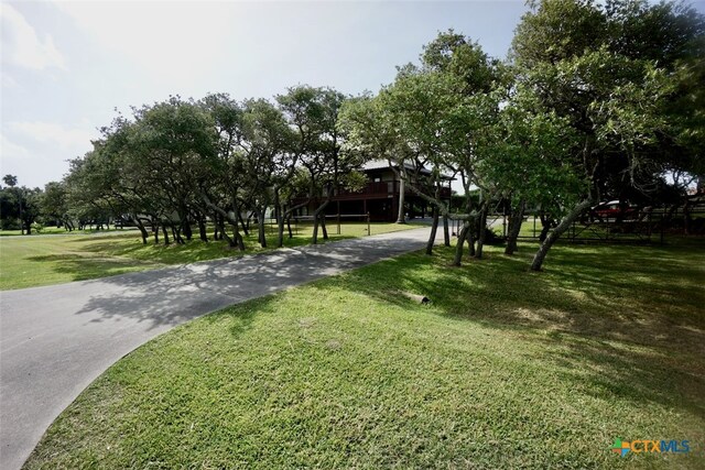 view of property's community with a lawn