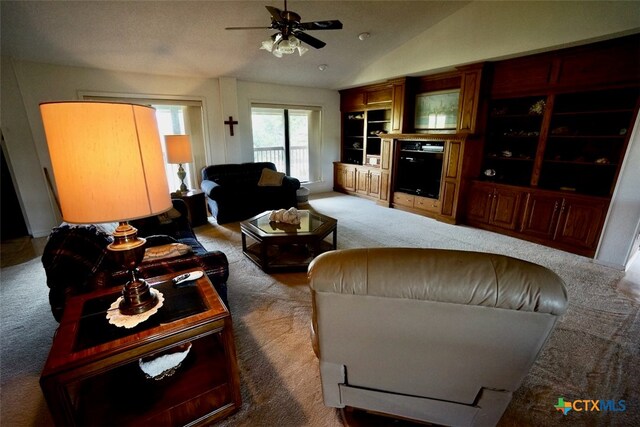 carpeted living room featuring vaulted ceiling and ceiling fan