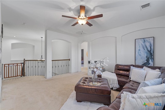 2474 Santa Barbara Loop, Round Rock, TX 78665 - carpeted living room featuring a ceiling fan and arched walkways