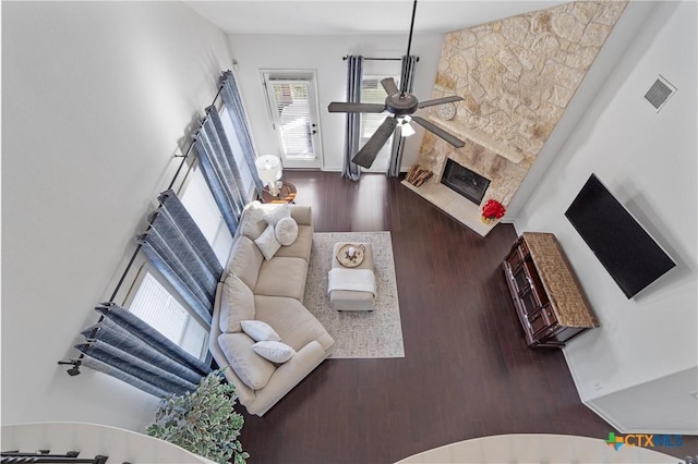 2474 Santa Barbara Loop, Round Rock, TX 78665 - living room featuring wood finished floors, a ceiling fan, a fireplace, and baseboards