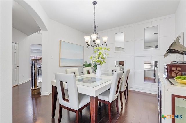 2474 Santa Barbara Loop, Round Rock, TX 78665 - dining area with arched walkways, dark wood-style floors, and a chandelier