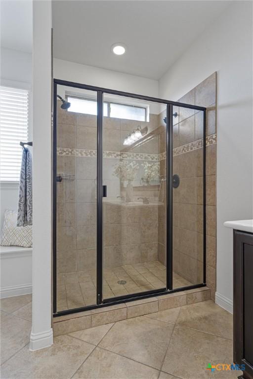 2474 Santa Barbara Loop, Round Rock, TX 78665 - bathroom featuring a shower stall, healthy amount of natural light, and vanity