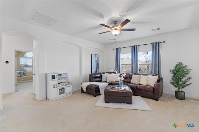 2474 Santa Barbara Loop, Round Rock, TX 78665 - living area featuring arched walkways, healthy amount of natural light, and light carpet