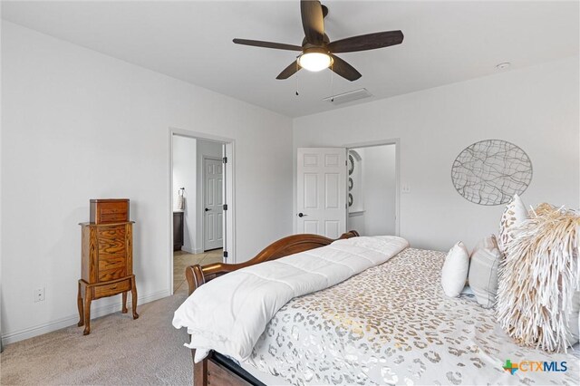 2474 Santa Barbara Loop, Round Rock, TX 78665 - bedroom with light carpet, baseboards, a ceiling fan, and connected bathroom