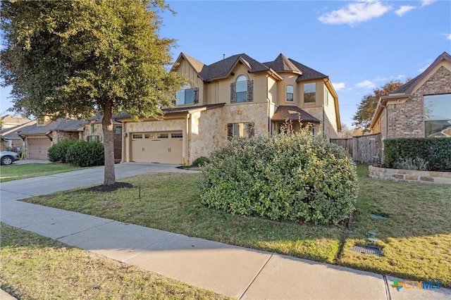2474 Santa Barbara Loop, Round Rock, TX 78665 - view of front of house with stone siding, driveway, an attached garage, and board and batten siding