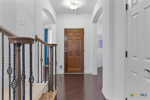 2474 Santa Barbara Loop, Round Rock, TX 78665 - foyer featuring arched walkways, stairway, wood finished floors, and baseboards
