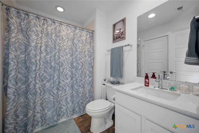 bathroom with recessed lighting, visible vents, toilet, vanity, and wood finished floors