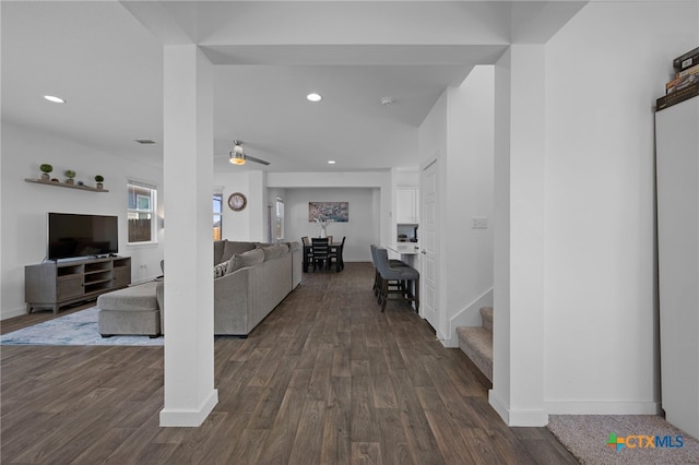 living area with dark wood-style floors, recessed lighting, stairway, and baseboards